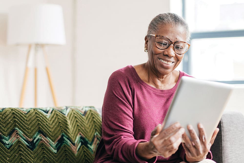 Senior Aged Woman with Tablet Filling out Aging Choices Checklist Senior Aged Woman with Tablet Filling out Aging Choices Checklist
