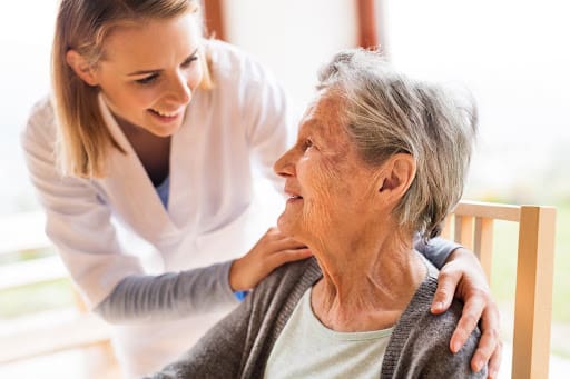 Senior Woman talking to Female Nurse