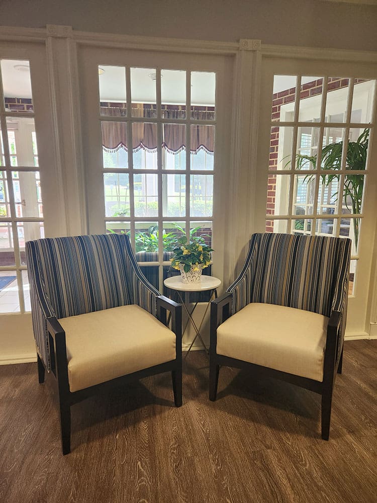 seating area with arm chairs next to windows