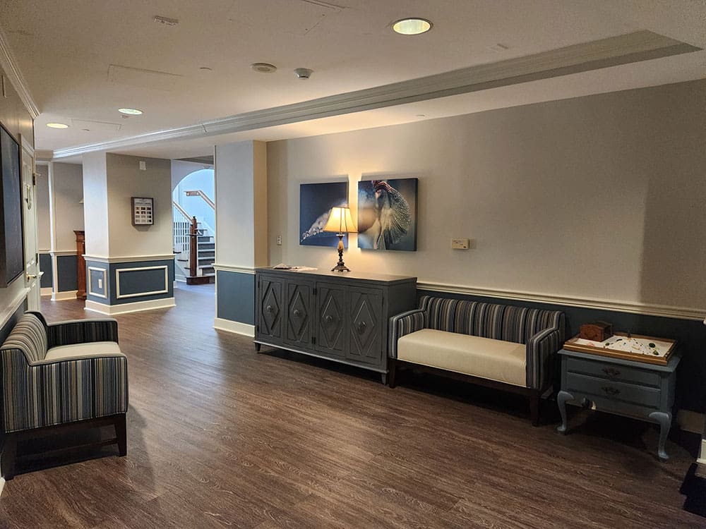 hallway with loveseats and art work