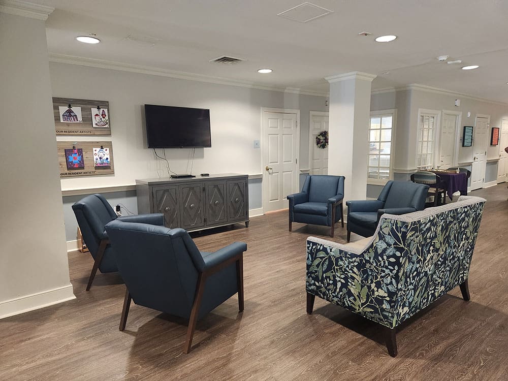 tv viewing area with seating and artwork
