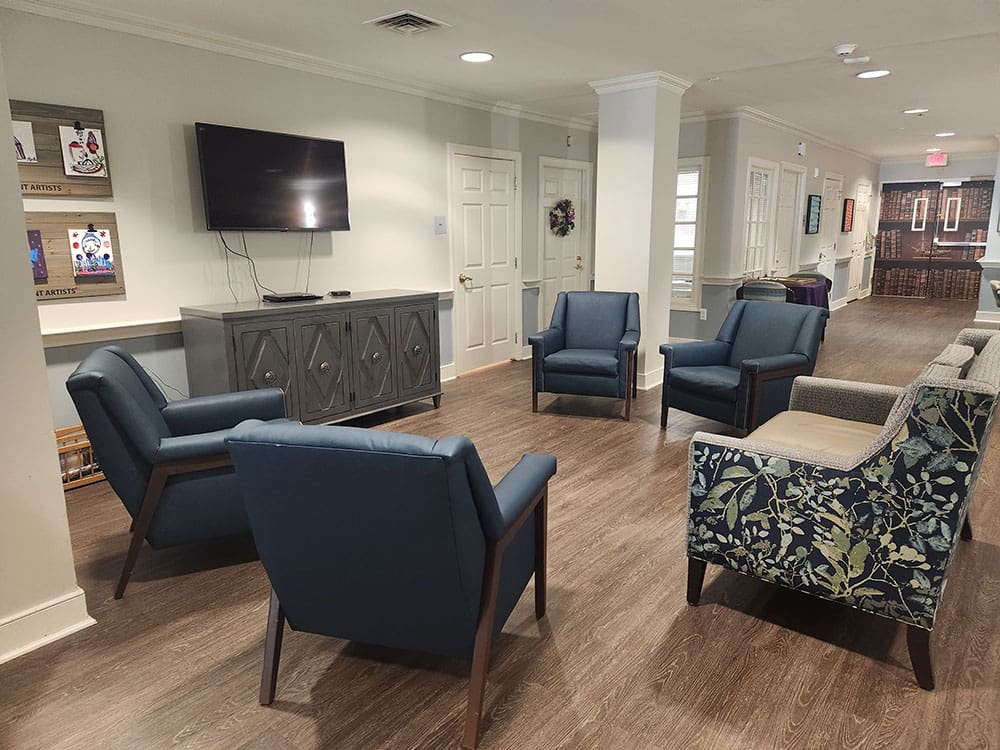 large open seating area with tv and art