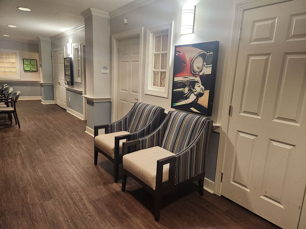 seating area with arm chairs and art