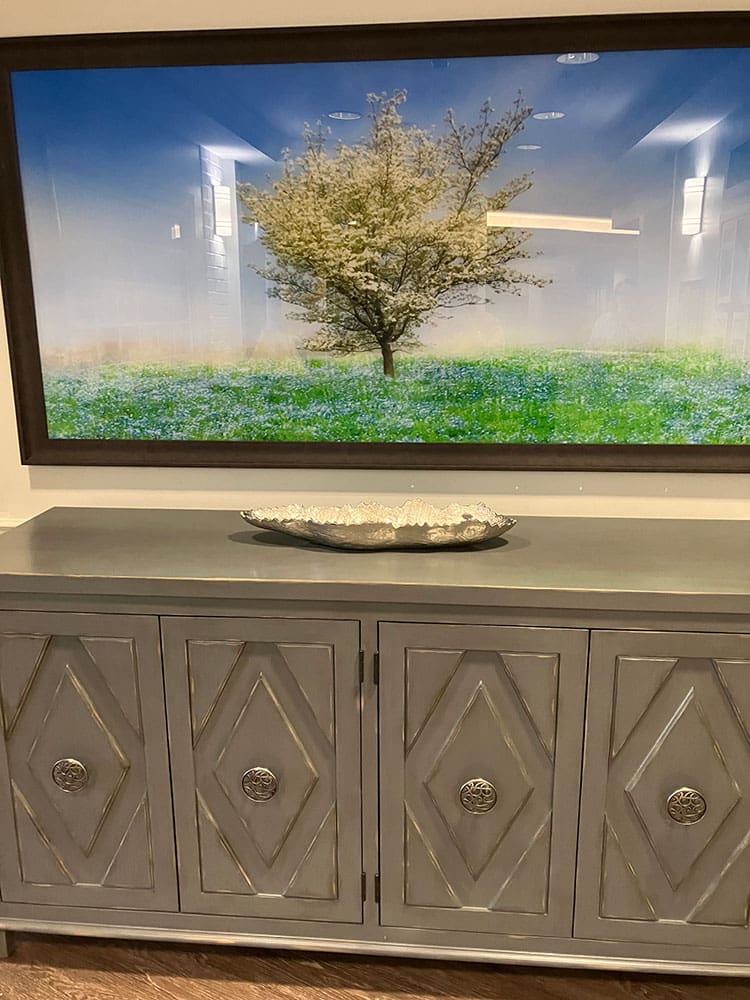 large tv above beautiful cabinet